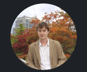 Picture of author with autumnal trees in background