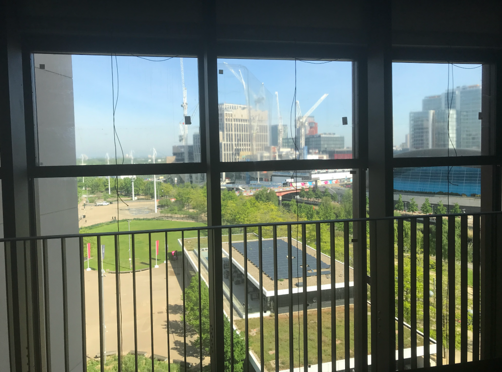 View from window of part of the olympic park- the canal, greenery, buildings and the construction of the London CVollege of Fashion 
