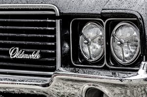 close up of oldsmobile headlights in monochrome